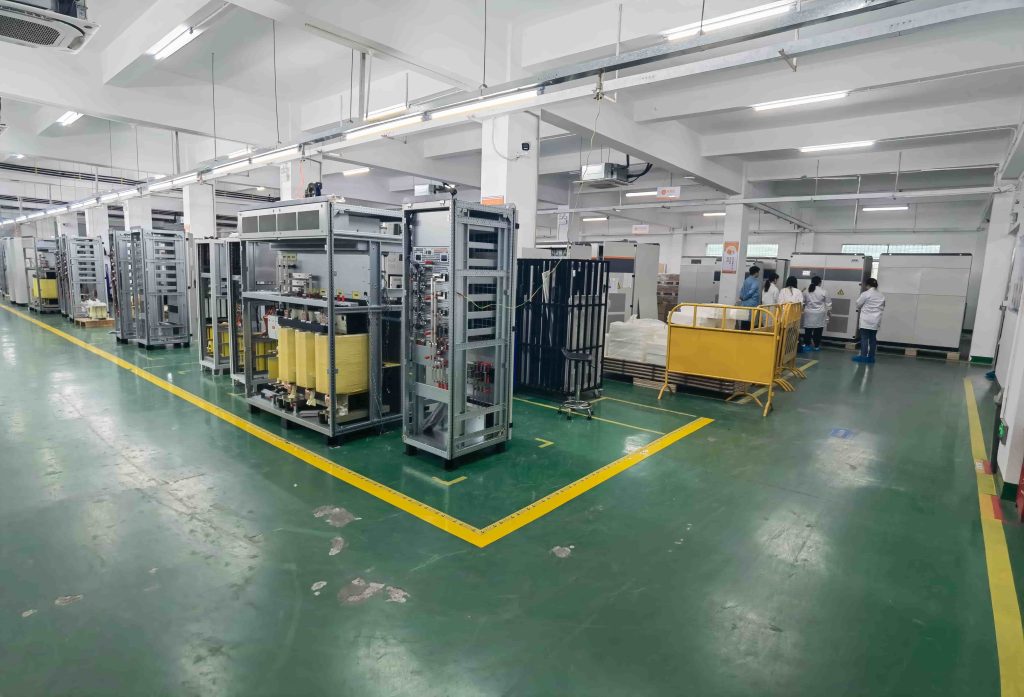 Engineers at the MegSolid manufacturing facility inspecting commercial and industrial solid-state energy storage cabinets.