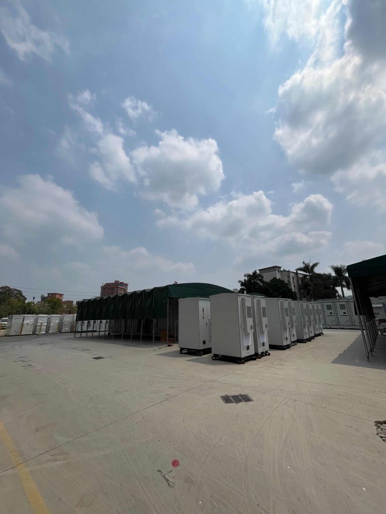 A large outdoor staging area filled with KRL Power hybrid commercial energy storage cabinets ready for industrial deployment.