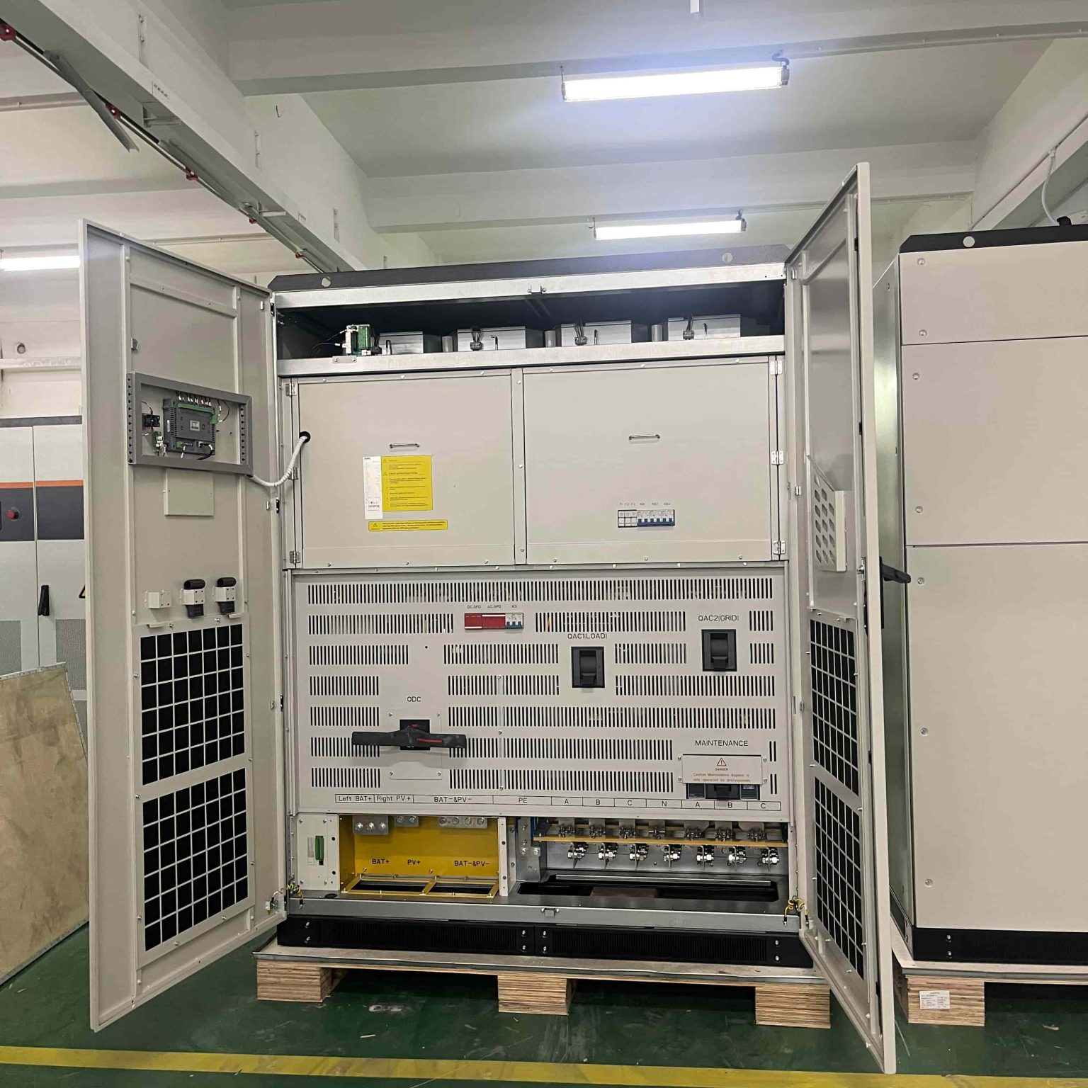 Internal wiring and breaker layout of a MegSolid hybrid commercial energy storage cabinet on the factory floor.