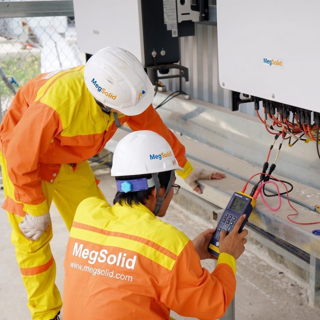 technical engineers conducting on-site diagnostic testing on a MegSolid hybrid solid-state inverter.