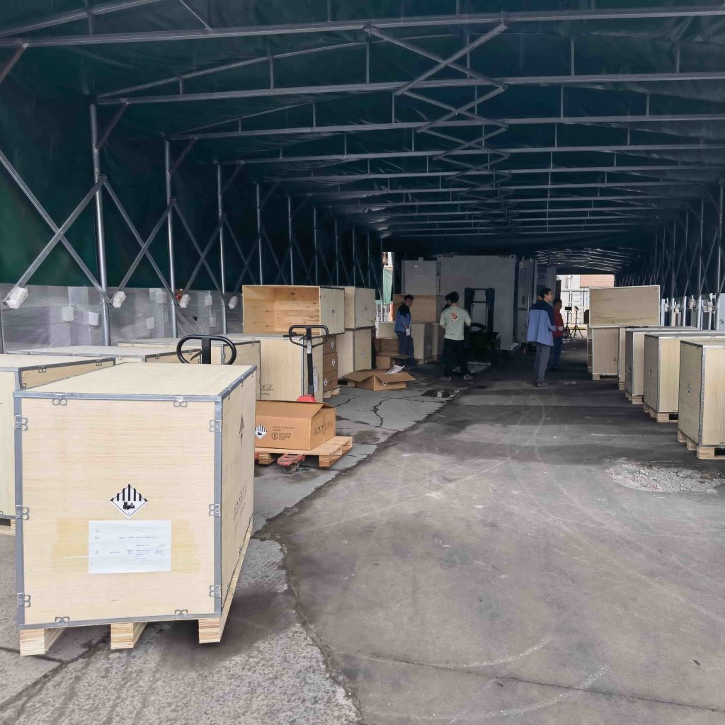 Rows of heavy-duty wooden shipping crates containing MegSolid hybrid commercial energy storage systems staged for global delivery.